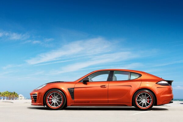 Orange Porsche on a blue sky background