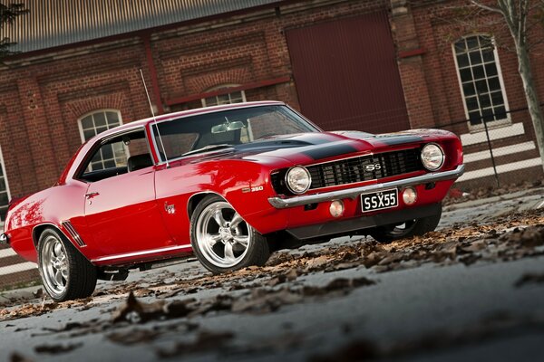 Red Chevrolet Camato SS on the background of the house