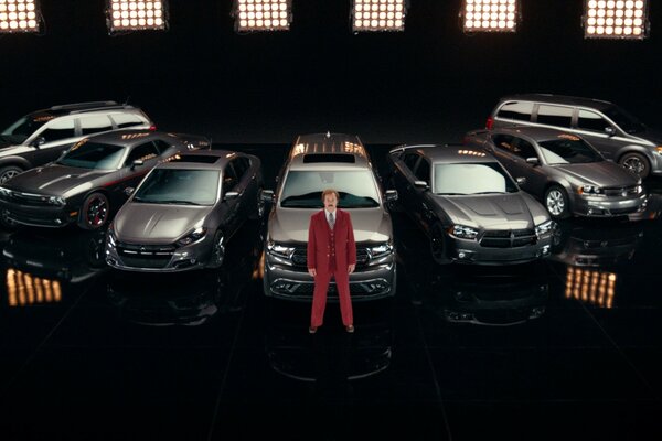 Seven cars of the same color and a man in a red suit