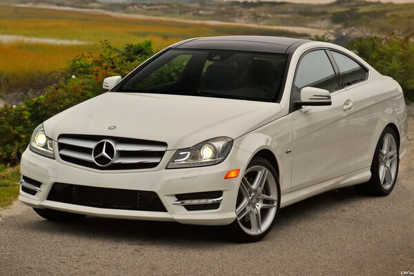 A beautiful, wonderful white Mercedes Coupe. Honestly, only the barefoot deserved to ride on such