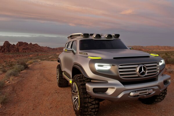 Mercedes benz in the desert with the lights on
