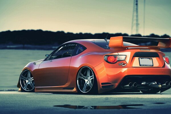 A racing car with a spoiler on the trunk