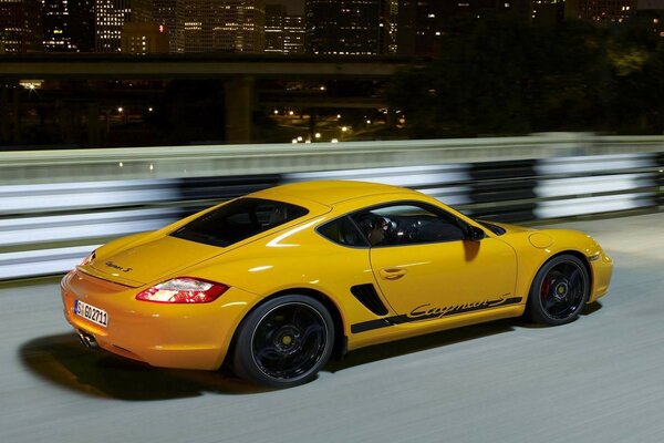 Porsche Cayman rushes along the night highway