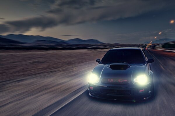 Subaru impreza black with bright headlights