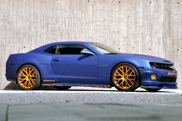 Blue matte car with yellow alloy wheels