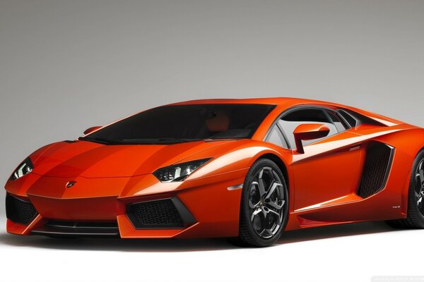 Orange lamborghini aventador supercar on a gray background