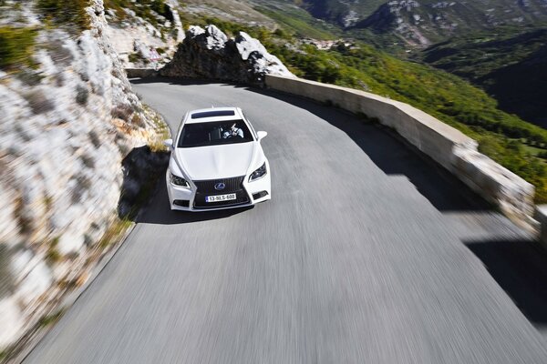 Lexus rushes along the mountain highway
