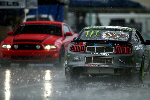 Two cars on rainy asphalt