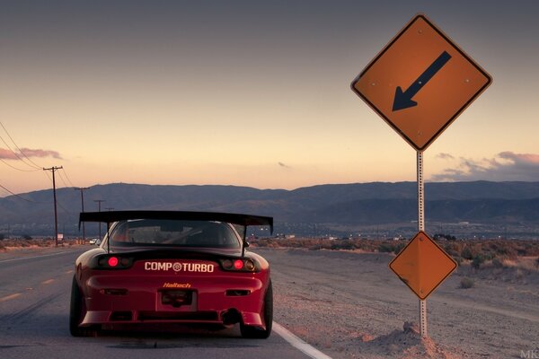 Mazda car at the road sign