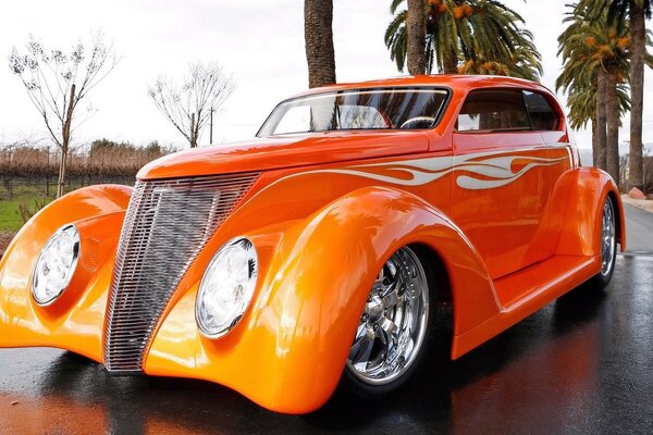 Retro car Ford orange on the background of palm trees