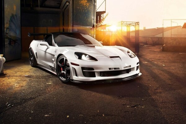 Sports car standing on the background of the setting sun