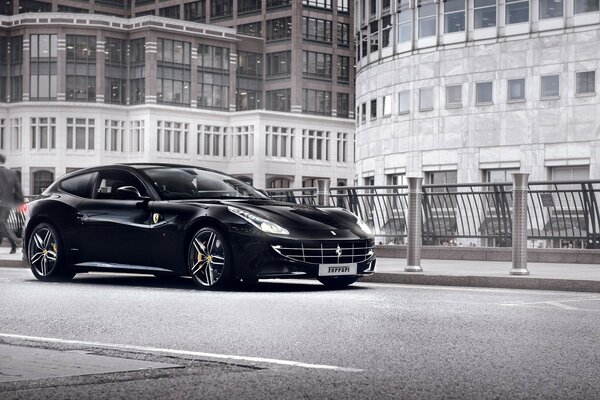 Black stylish car on the streets of a gray city