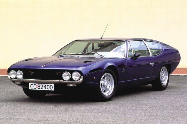 A vintage Lamborghini car stands on the asphalt