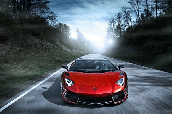 A red lamborghini is flying on an empty highway