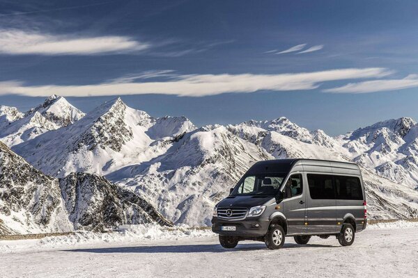 Spacious mercedes benz on the background of snow-capped peaks