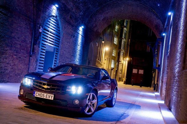 Black Chevrolet Camaro in a night alley