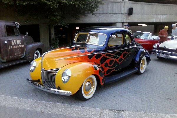 Retro car classic in bright orange and black color