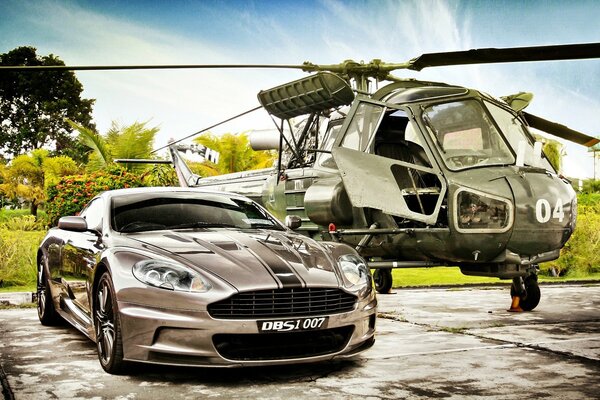 Aston Martin-une voiture à côté d un hélicoptère