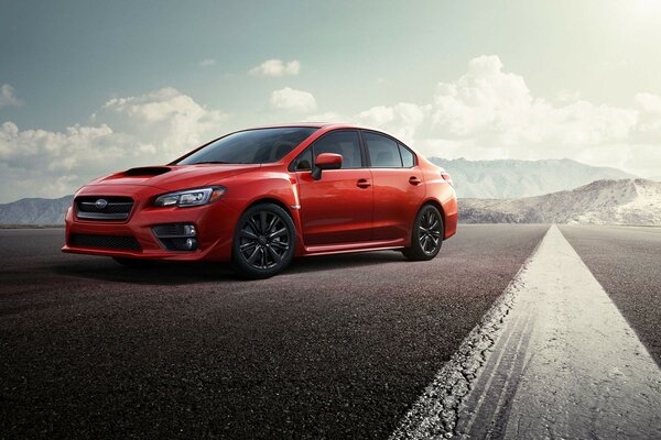 Red subaru car on the background of mountainous terrain