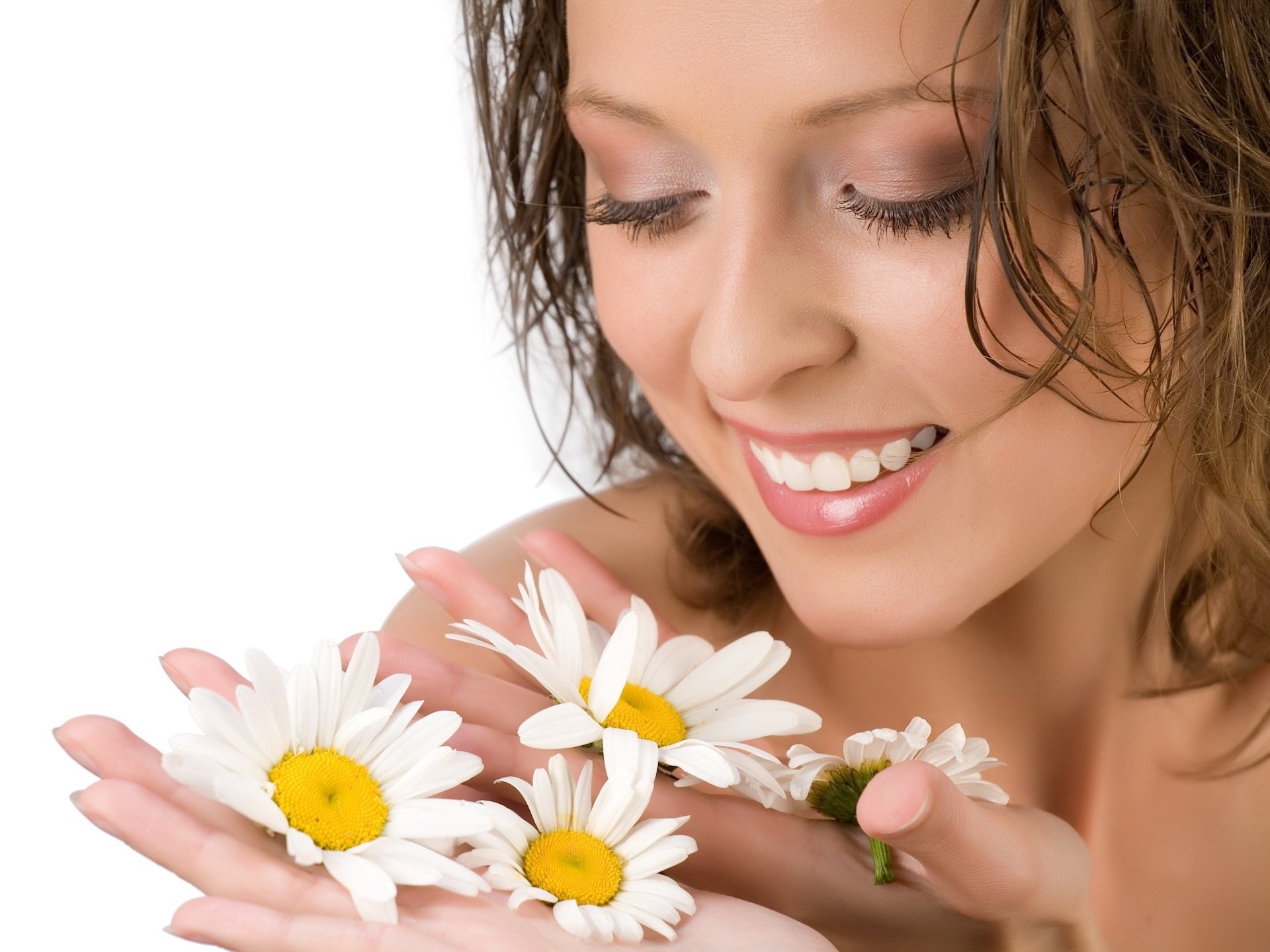 light makeup chamomile in the hand flowers girl tenderness smile spring chamomile face beauty brown hair