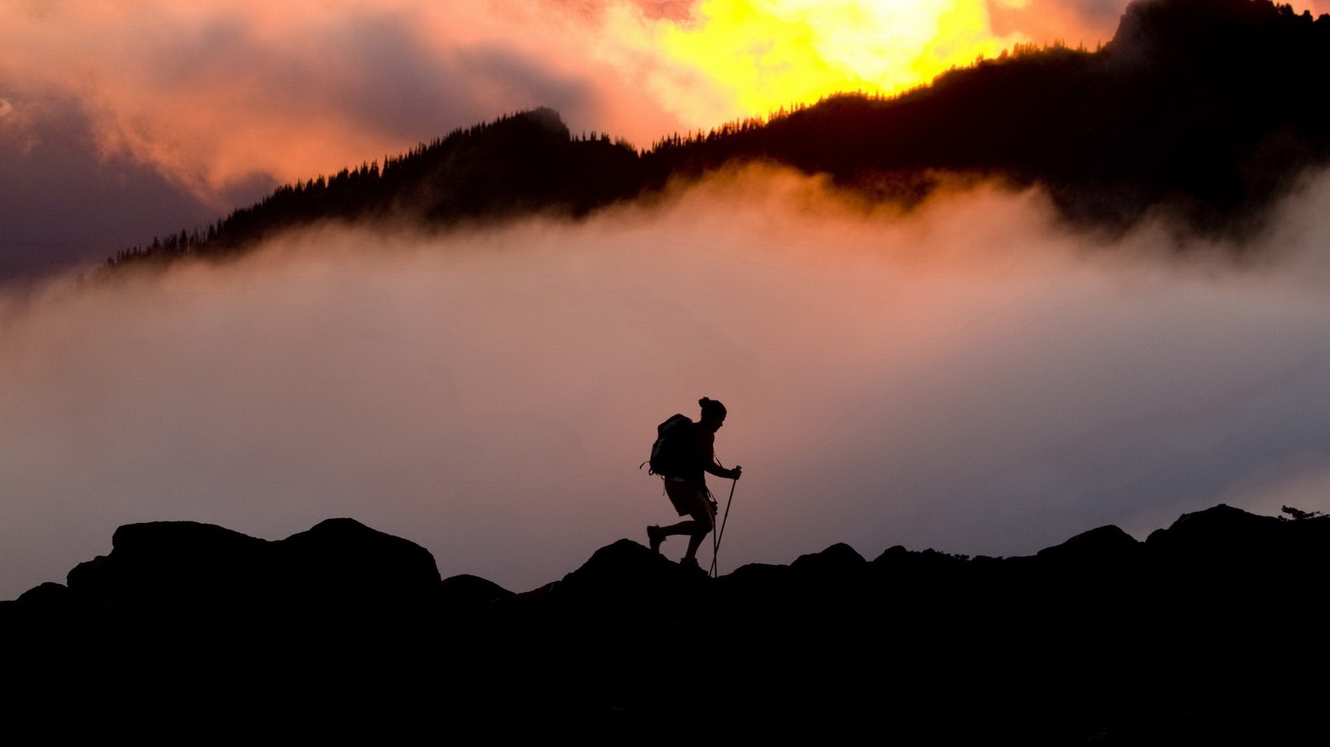 the lonely traveler sunset fog mountains people