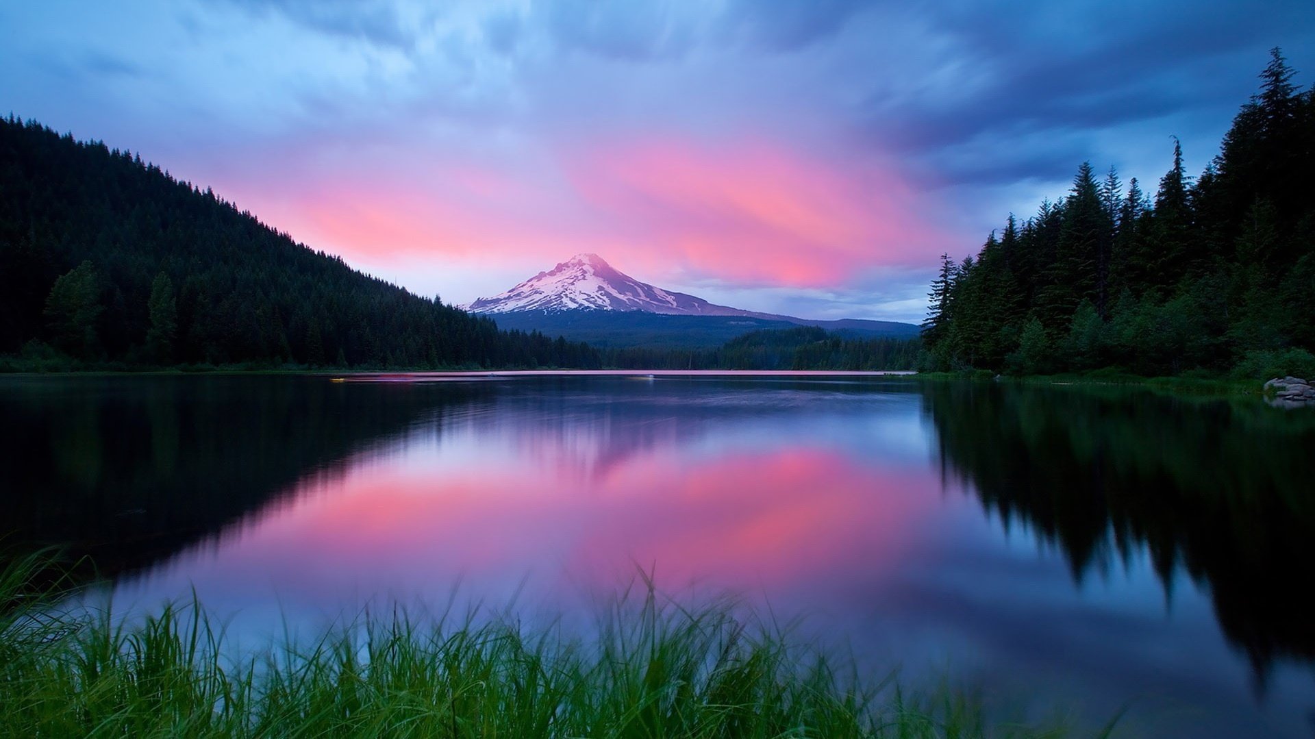 twilight pink sky forest mountains water lake sunset lilac sky reflection landscape nature trees tree grass surface mountain cloud