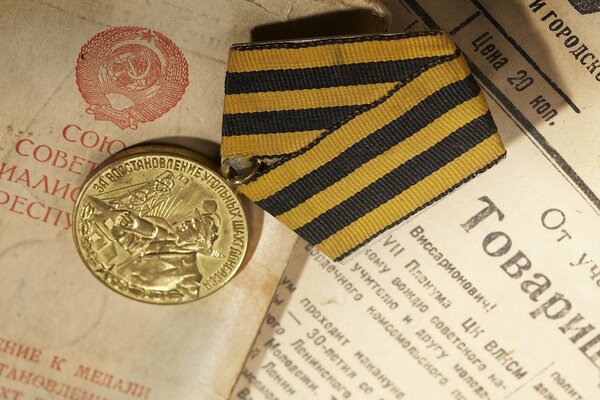 Medal on a ribbon on the background of a newspaper