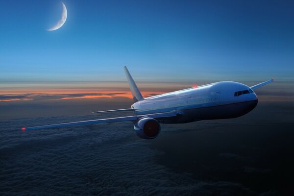 Airplane over the evening clouds with the moon