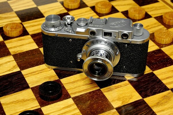 Soviet camera on the background of a chessboard