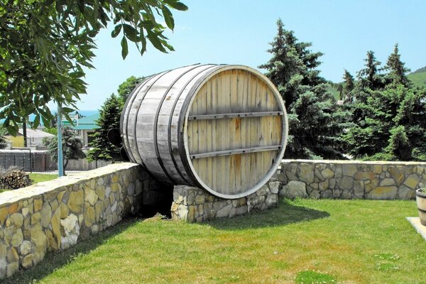 Botte di legno tra il cielo blu e gli abeti