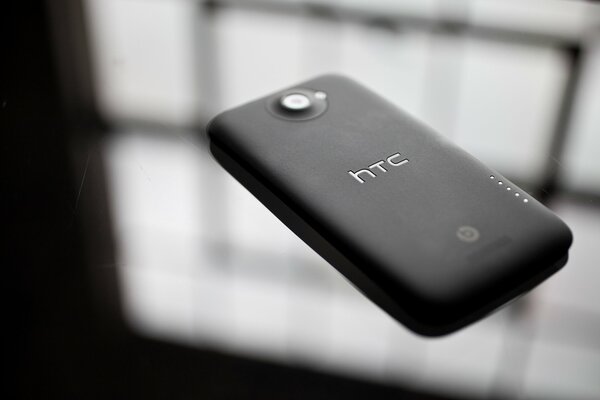 Htc one x smartphone black on glass