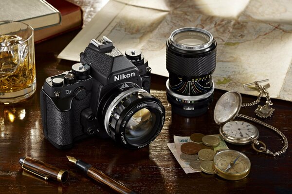 Photo collage with a camera coins and a watch