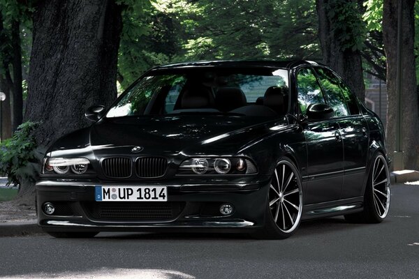 Black bmw e39 sedan glossy car with black tires