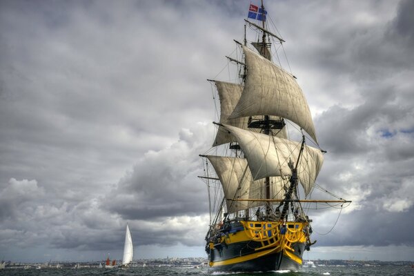 An old frigate with sails raised at sea