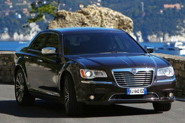 Lancia sedan on the background of the sea coast