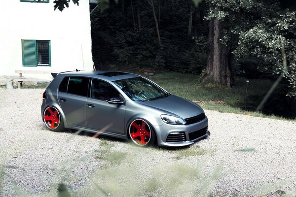 Silver Volkswagen golf with red rims