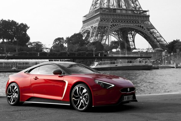 Sports car on the background of the river and cruise liners