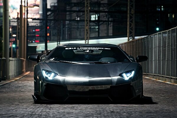 Lamborghini Aventador with lights on at night