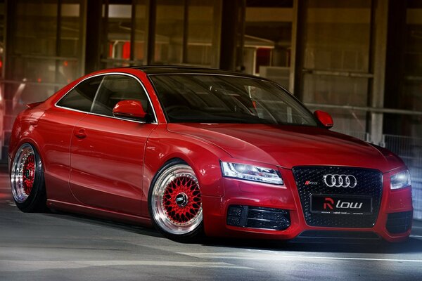 Red audi a5 on a city road