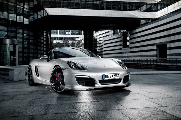 Silver Porsche at the entrance to the building