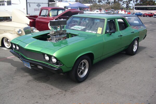 Chevelle racing car is green in the parking lot