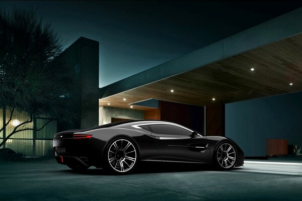 Black car on the background of a luxury house at night