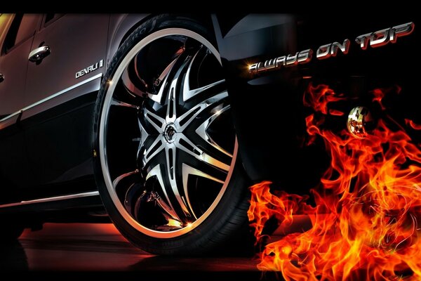 Fuego bajo la rueda de un coche negro
