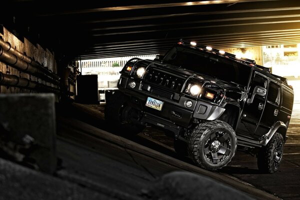 SUV Hummer negro con faros encendidos