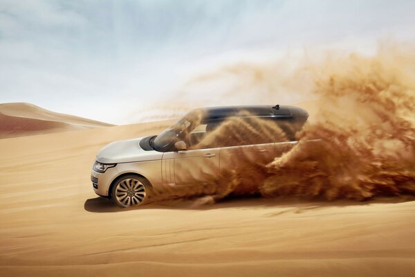 The rover rushes leaving waves of sand behind it