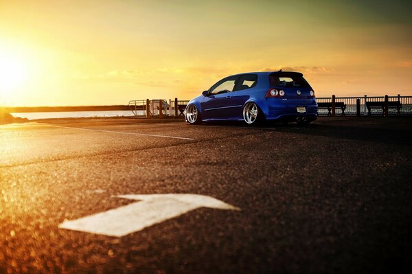 Blue car at sunset