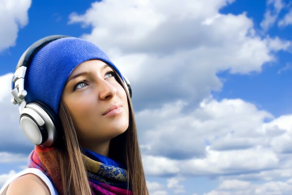 Belle fille dans un casque sur fond de ciel