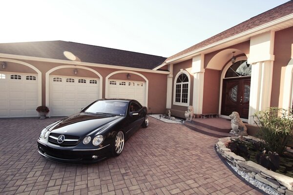 The car is chained in the yard of a private house