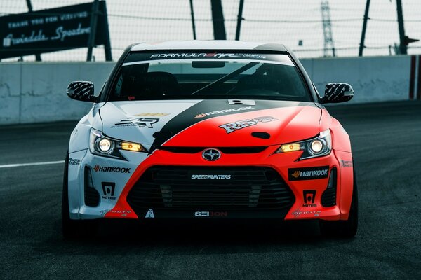 Racing red and gray car on the track