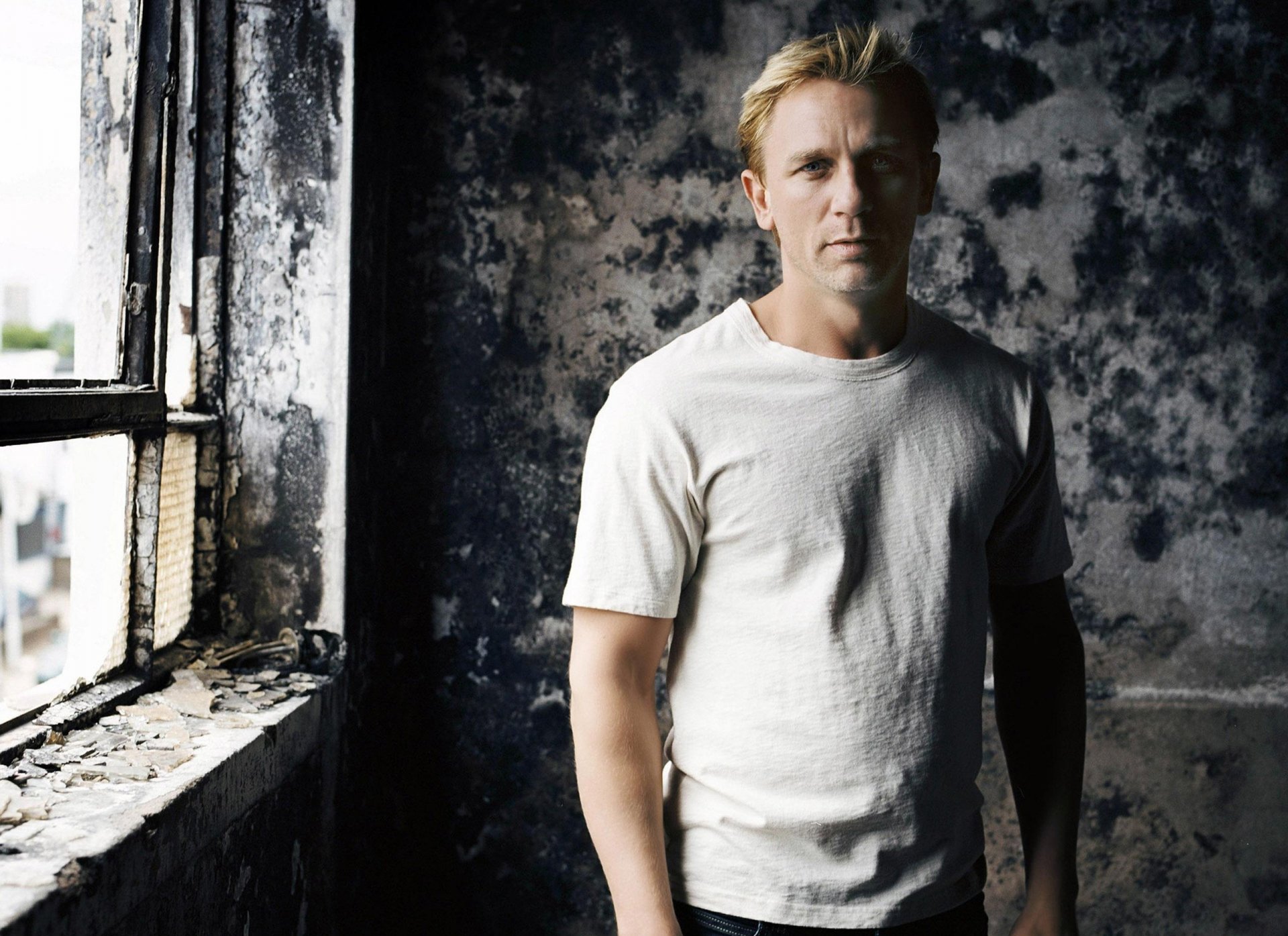 daniel blonde james bond look actor blonde window abandoned house white t-shirt celebrity guy face